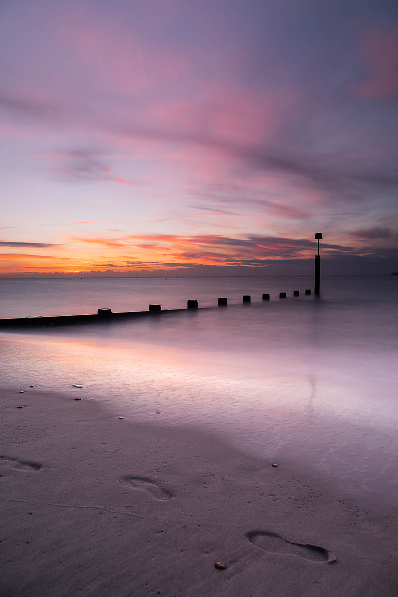 Sunrise at Groyne along Boscombe Beach, Dorset, England. Buy a fine art print.