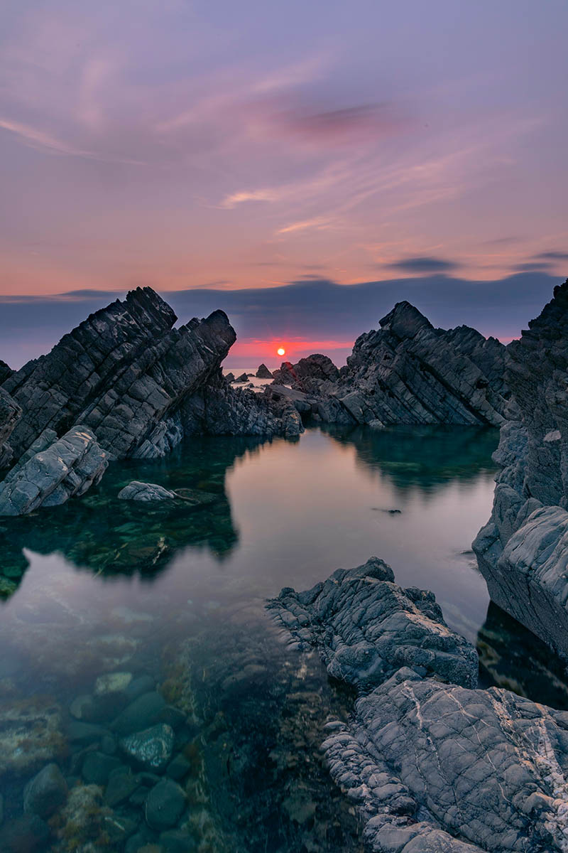 Sunset at Hartland Quay in Devon, England. Buy a fine art print.