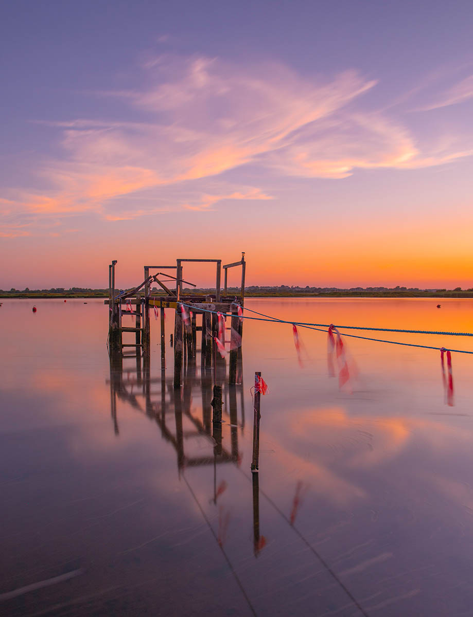 Broken jetty in Christchurch Harbour, Dorset, England. Buy a fine art print.