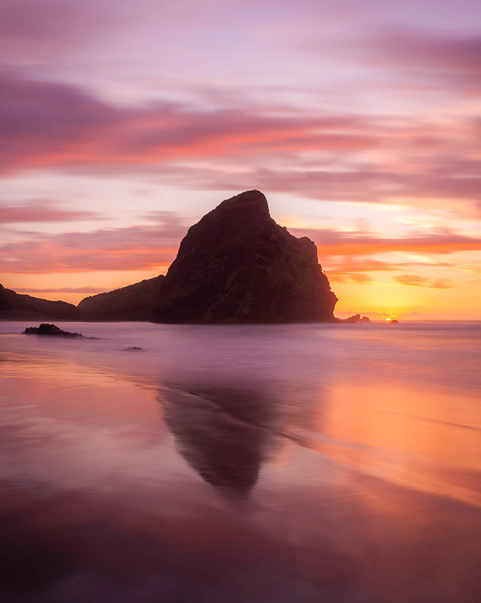 Sunset at Piha Beach, North Island, New Zealand.